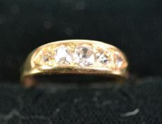 18ct GOLD RING with a lozenge shaped setting of 5 old cut diamonds graduating from the centre,