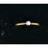 18ct GOLD AND PLATINUM RING set with a small round brilliant cut solitaire diamond, .05ct, 1.2