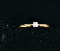 18ct GOLD AND PLATINUM RING set with a small round brilliant cut solitaire diamond, .05ct, 1.2