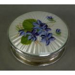 GEORGE V GUILLOCHE ENAMELLED SILVER PILL BOX, of circular form with gilt interior and floral painted