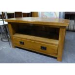 AN OAK CORNER TELEVISION STAND WITH OPEN COMPARTMENT AND ONE LONG DRAWER BELOW