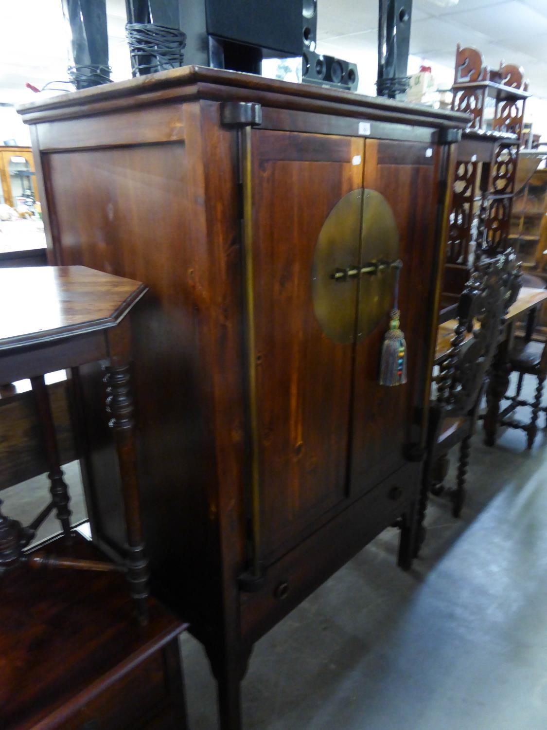 A REPRODUCTION DARKWOOD CUPBOARD  OF ORIENTAL STYLE, HAVING TWO CUPBOARD DOORS ABOVE A LONG DRAWER