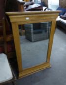 A PIER MIRROR, IN LIGHT OAK FRAME