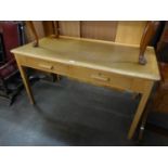 A LIGHT OAK DESK WITH PANEL END SUPPORTS AND A LIGHT OAK OFFICE WRITING TABLE, OBLONG WITH TWO