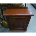 A SMALL DARK STAINED CUPBOARD WITH SINGLE PANEL DOOR