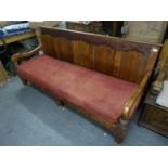 A PROBABLY PITCH PINE PANEL BACK SETTLE WITH CUSHION SEAT