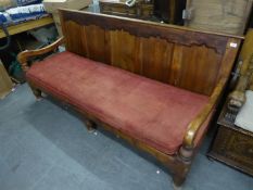 A PROBABLY PITCH PINE PANEL BACK SETTLE WITH CUSHION SEAT