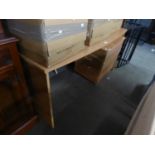 A LIGHT WOOD MODERN DESK AND CHEST OF THREE DRAWERS