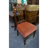 A MAHOGANY CARVED SINGLE CHAIR ON TURNED FRONT SUPPORT AND CASTORS, HAVING UPHOLSTERED SEAT