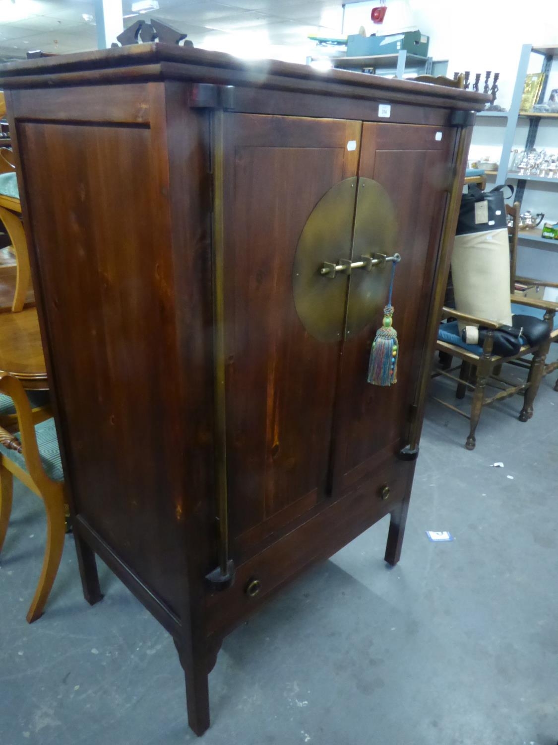 A REPRODUCTION DARKWOOD CUPBOARD  OF ORIENTAL STYLE, HAVING TWO CUPBOARD DOORS ABOVE A LONG DRAWER - Image 2 of 2