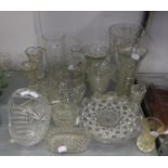 A HEAVY CUT GLASS BEAKER SHAPED VASE; TWO SMALLER CUT GLASS VASES AND OTHER GLASS  VASES ETC..