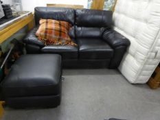 A MODERN BLACK HIDE TWO SEATER SETTEE WITH SADDLE ARMS AND A MATCHING LOUNGE ARMCHAIR (2)