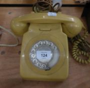 A YELLOW ROTARY DIAL TELEPHONE RECEIVER