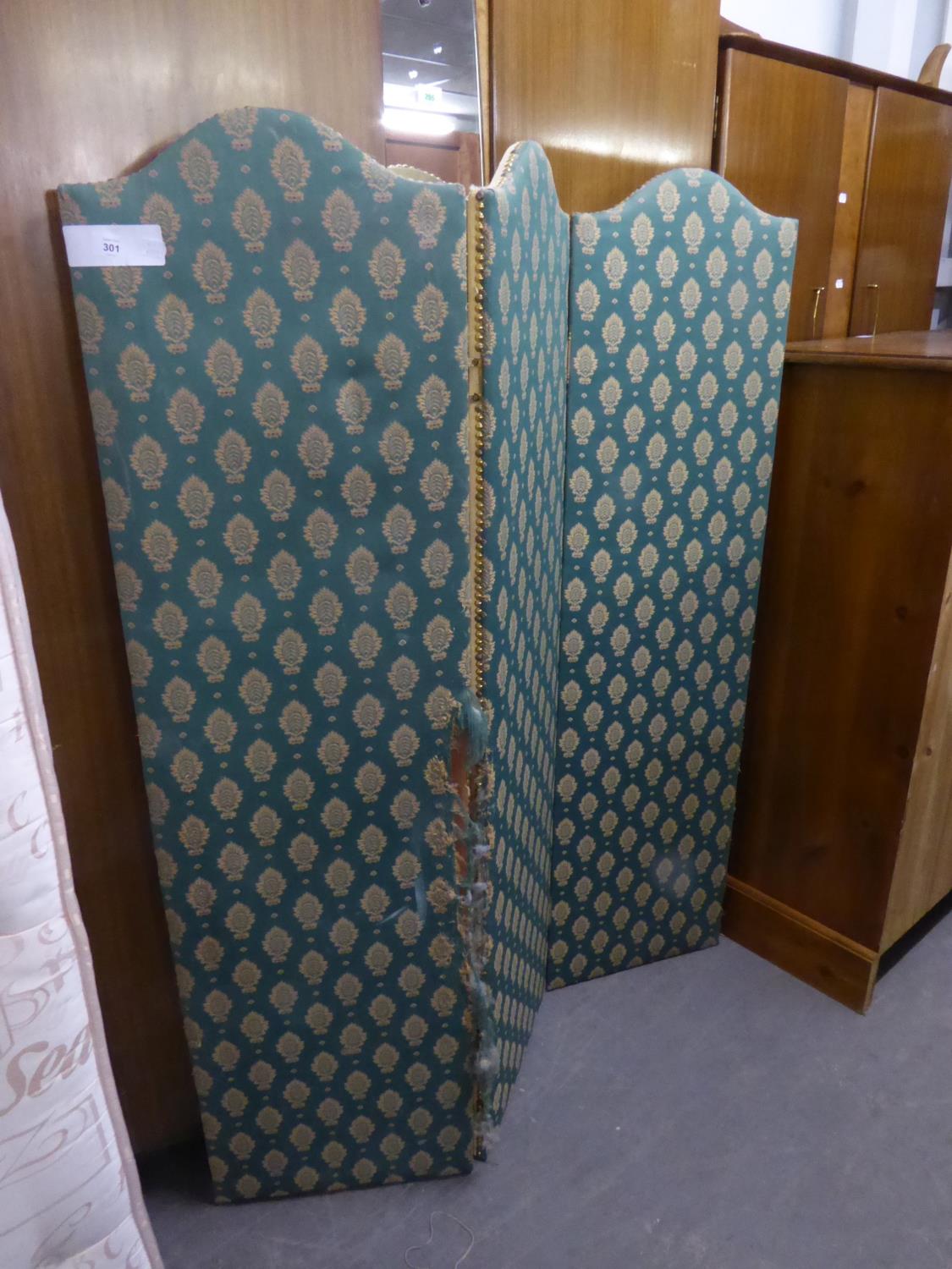 A FABRIC COVERED FOUR-FOLD SCREEN