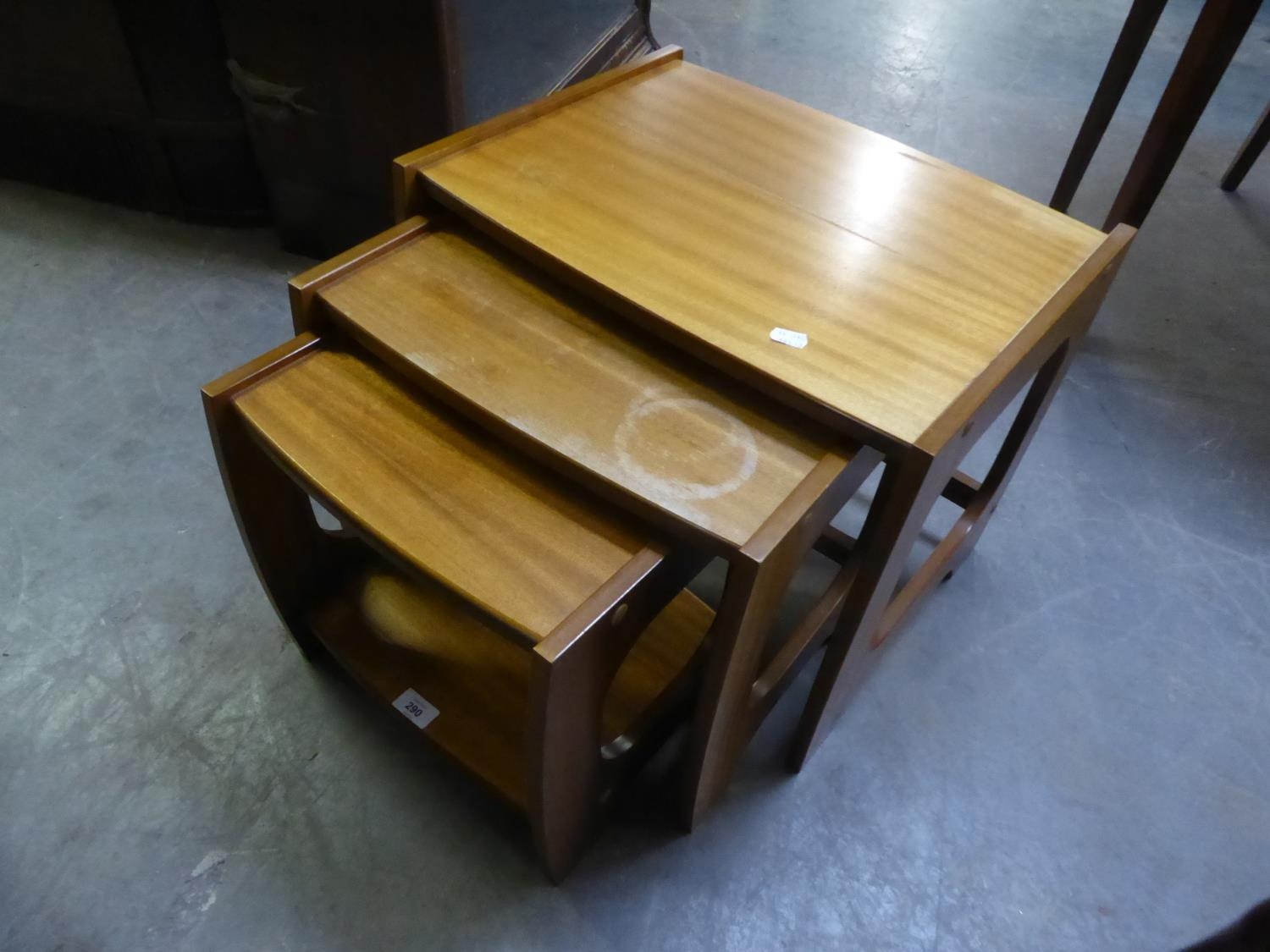 A NEST OF THREE G-PLAN STYLE MAHOGANY OBLONG COFFEE TABLES, ON CONTINUOUS SUPPORTS