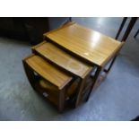 A NEST OF THREE G-PLAN STYLE MAHOGANY OBLONG COFFEE TABLES, ON CONTINUOUS SUPPORTS