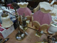 A PAIR OF BRASS PILLAR ELECTRIC TABLE LAMPS AND SHADES WITH DEEP FRINGES; A HEAVY BRASS TWO BRANCH