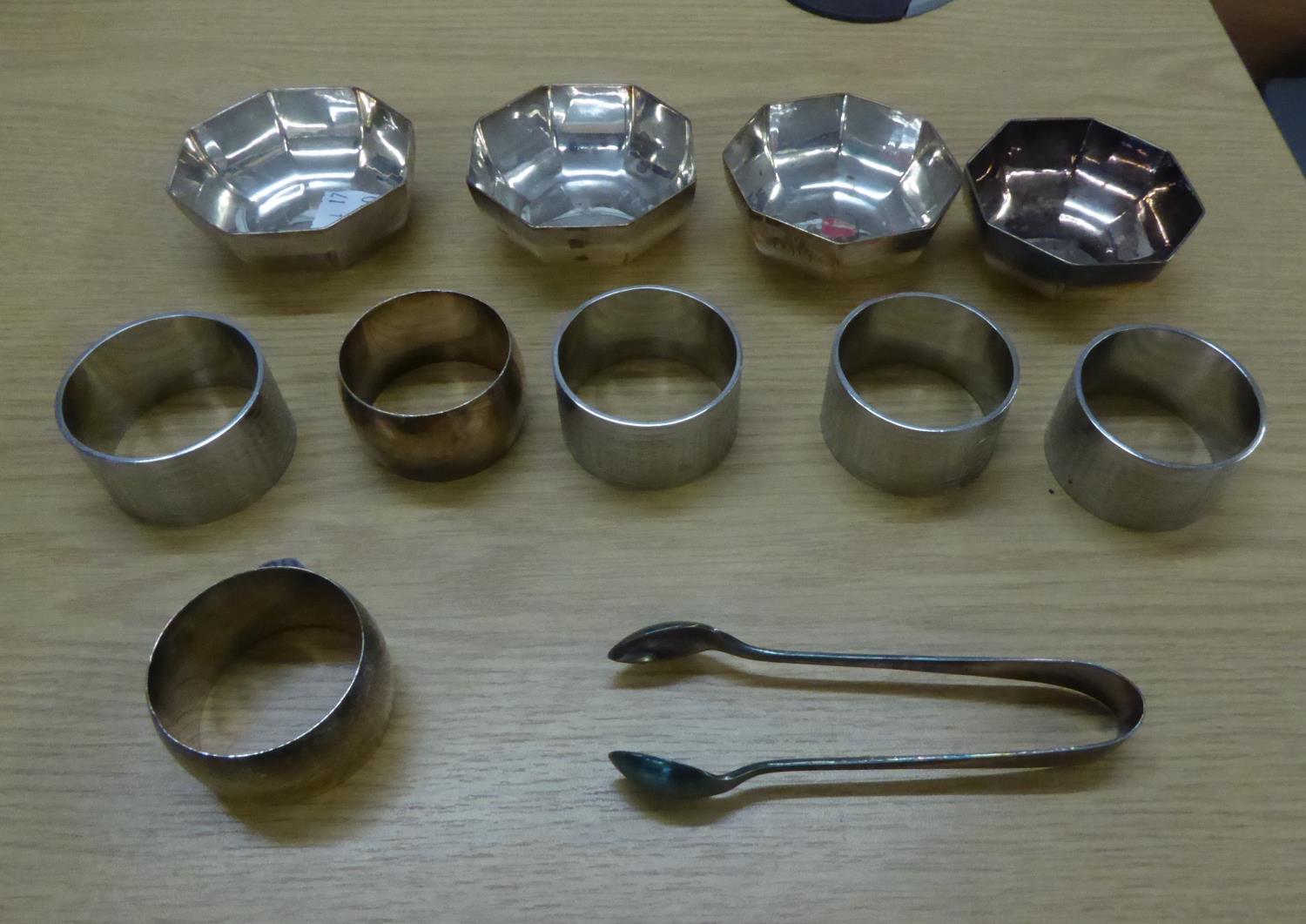 A SET OF FOUR ELECTROPLATE PLAIN CIRCULAR NAPKIN RINGS; A SET OF THREE ELECTROPLATE ENGINE TURNED