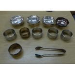 A SET OF FOUR ELECTROPLATE PLAIN CIRCULAR NAPKIN RINGS; A SET OF THREE ELECTROPLATE ENGINE TURNED