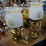 A PAIR OF BRASS OIL TABLE LAMPS WITH WHITE OPAQUE MOULDED GLASS SHADES WITH FRILL TOP AND A COPPER