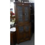 JACOBEAN STYLE OAK DOUBLE CORNER CUPBOARD, WITH A PAIR OF LEAD LIGHT DOORS OVER A PAIR OF LEAD LIGHT