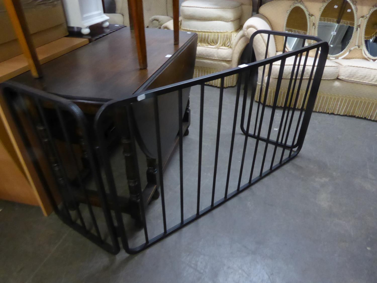 A HEAVY BLACK WROUGHT IRON THREE-SECTION FOLDING FIRE-GUARD