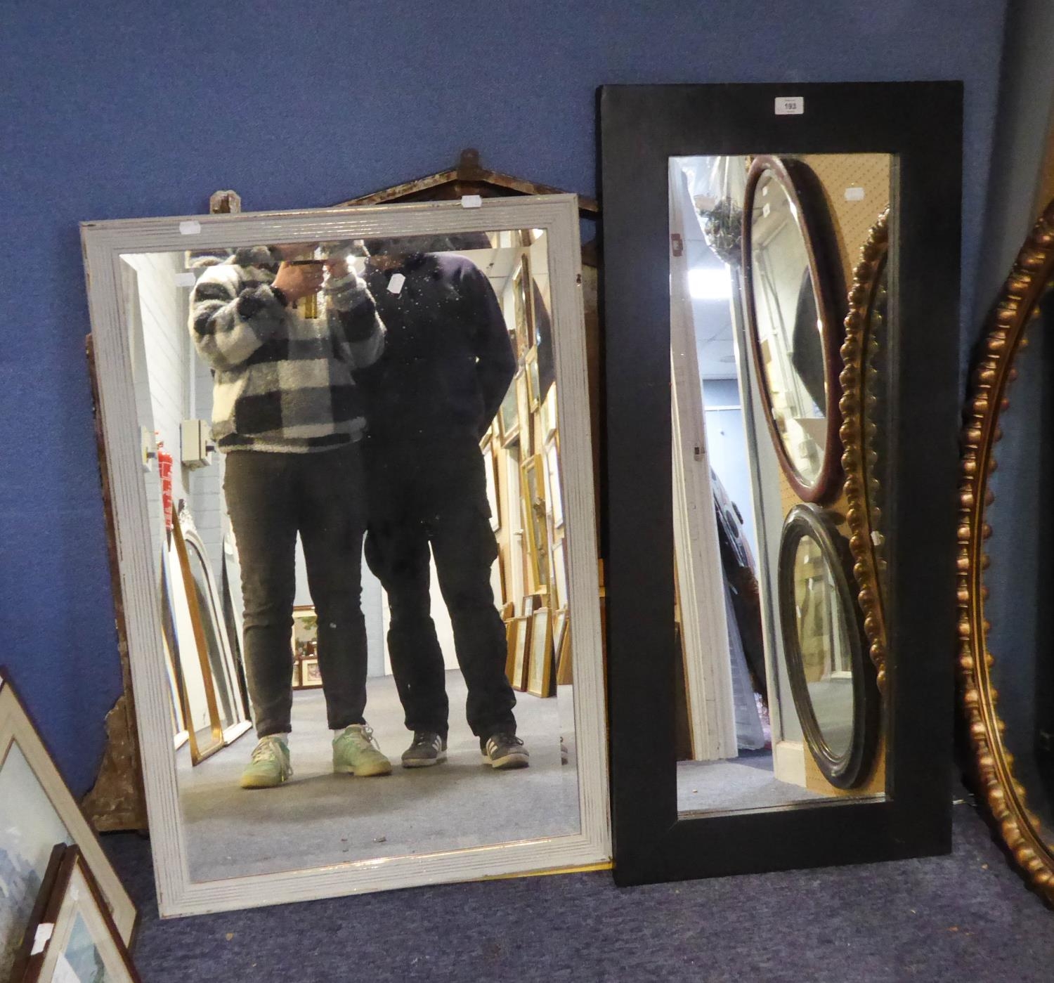 TWO PAINTED OBLONG WALL MIRRORS, one modern in heavy black frame, 43? x 19 ¾?, the other bevel edged