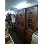 JACOBEAN STYLE CARVED OAK BREAKFRONT LIBRARY BOOKCASE, THE TOP WITH FOUR LEAD LIGHT DOORS, THE
