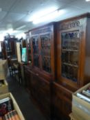 JACOBEAN STYLE CARVED OAK BREAKFRONT LIBRARY BOOKCASE, THE TOP WITH FOUR LEAD LIGHT DOORS, THE