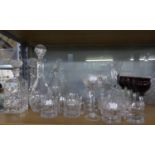 FOUR MODERN CUT GLASS DECANTERS AND STOPPERS, including one initialled J, together with a SMALL