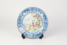 CHINESE QING DYNASTY PORCELAIN PLATE, the centre famille rose enamelled with figures in a summer