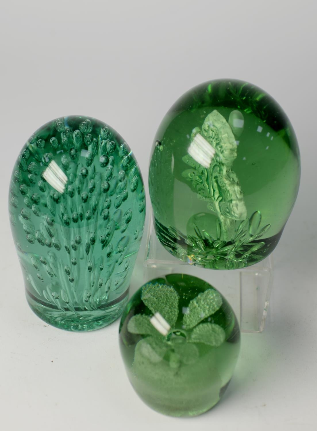 THREE VICTORIAN GREEN GLASS DUMPS, comprising: ONE WITH A SULPHIDE INCLUSION OF A THISTLE, another