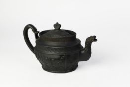 EARLY NINETEENTH CENTURY MOULDED BLACK BASALT POTTERY TEAPOT AND COVER, of oval form with serpent