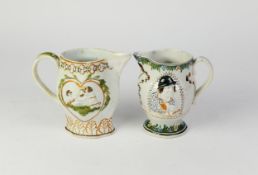 TWO NINETEENTH CENTURY MOULDED PRATT WARE POTTERY JUGS, one of footed form with scroll handle,