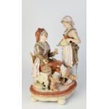 AN EARLY 1900's GERMAN BISQUE PORCELAIN FIGURAL GROUP of a seated cavalier  with serving maid,