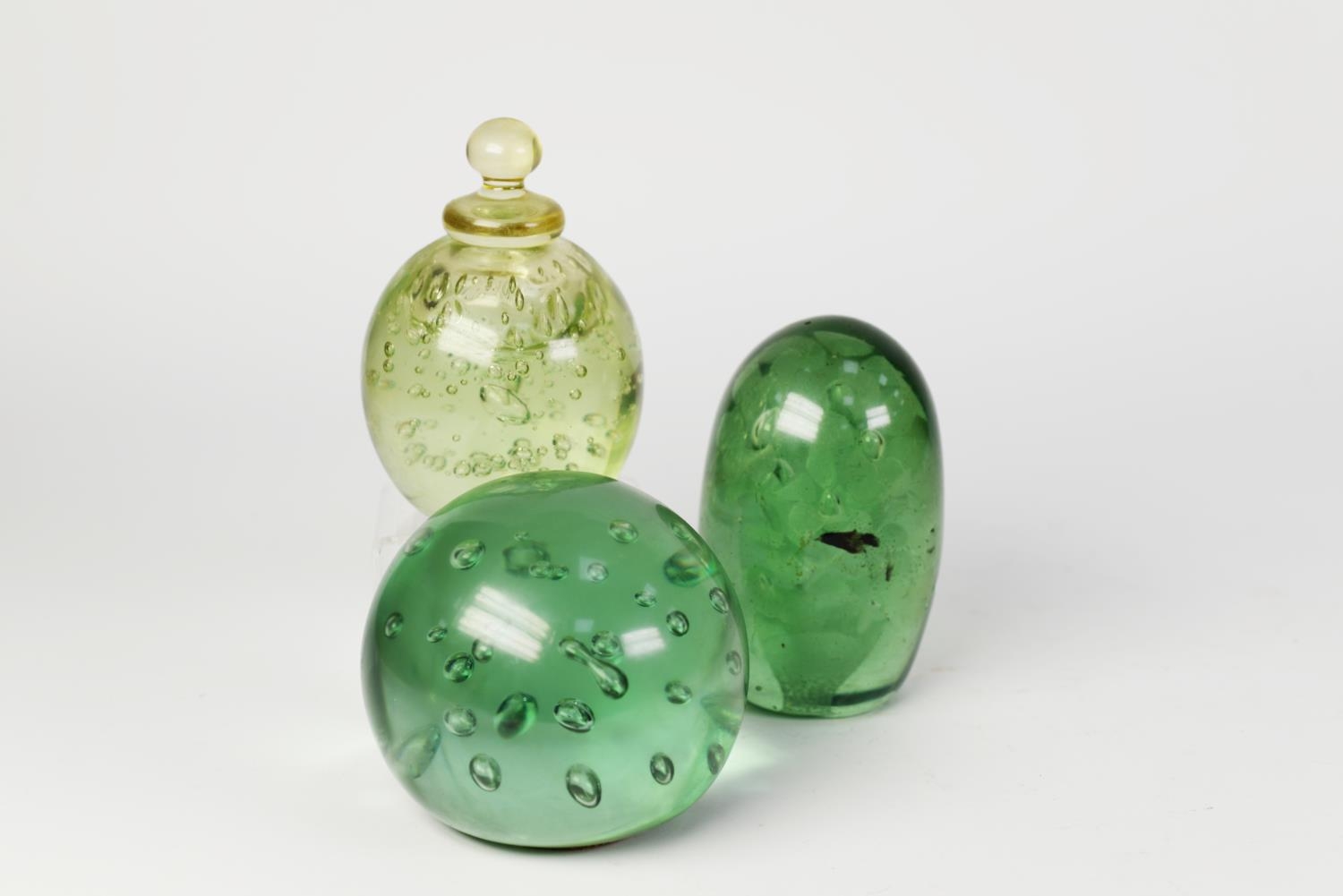 TWO VICTORIAN GREEN GLASS DUMPS, one with floral inclusions, the other with bubble inclusions,