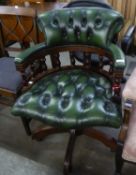 A CAPTAIN?S CHAIR, BUTTON UPHOLSTERED IN GREEN HIDE, REVOLVING ON A MAHOGANY FIVE SPUR BASE