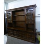 A LARGE OAK DISPLAY SIDE UNIT WITH OPEN SHELVES, GLAZED DOORS, THE ADVANCED BASE WITH FOUR