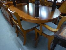 A YEW-WOOD DINING ROOM SUITE, COMPRISING; AN OVAL EXTENDING DINING TABLE, SIX CHAIRS (4 + 2) AND A
