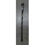AN AFRICAN CARVED EBONY WALKING STICK WITH AFRICAN MALE HEAD TOP