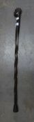 AN AFRICAN CARVED EBONY WALKING STICK WITH AFRICAN MALE HEAD TOP