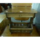 AN OAK OBLONG COFFEE TABLE, WITH DRAWER AND PERIODICAL RACK BELOW