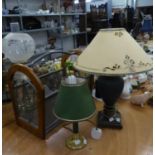 A TEAK, METAL AND MESH PANELLED PERIODICAL RACK AND AN URN SHAPED TABLE LAMP WITH DECORATED
