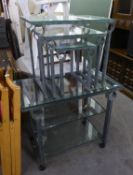 A GREY WROUGHT IRON SIDE TABLE OR TROLLEY, WITH PLATE GLASS TOP AND TWO PLATE GLASS UNDERSHELVES, ON