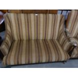 A LATE VICTORIAN SEMI-WINGED SMALL DRAWING ROOM SETTEE, COVERED IN STRIPED FABRIC