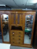EDWARDIAN LARGE CARVED BEACONSFIELD WARDROBE, THE CENTRAL SECTION HAVING TWO SMALL CARVED DOORS OVER