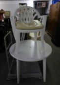 A WHITE PLASTIC CIRCULAR TABLE AND TUB ARMCHAIR