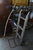 A VINTAGE SCYTHE, WITH LONG WOODEN HANDLE AND A VINTAGE SACK BARROW (2)