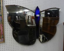 A STYLISH FRAMELESS WALL MIRROR, IN THE SHAPE OF A BUTTERFLY, HAVING BLUE GLASS CENTRAL SECTION