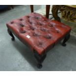 AN OBLONG STOOL, BUTTON UPHOLSTERED IN CRIMSON HIDE ON CABRIOLE LEGS
